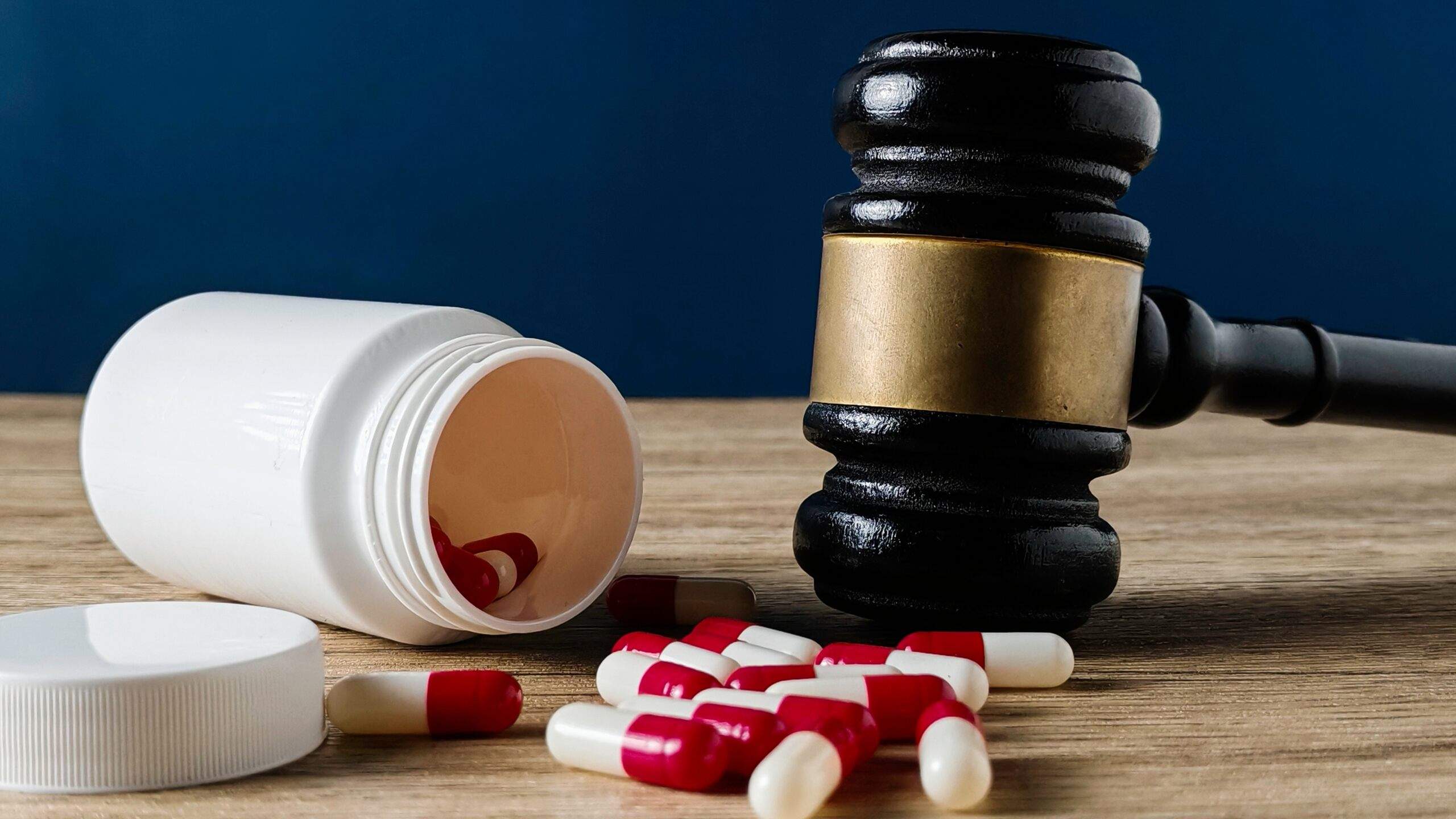 Court gavel beside prescription pills symbolizing a Tulsa Dangerous Drug Attorney handling pharmaceutical injury claims.