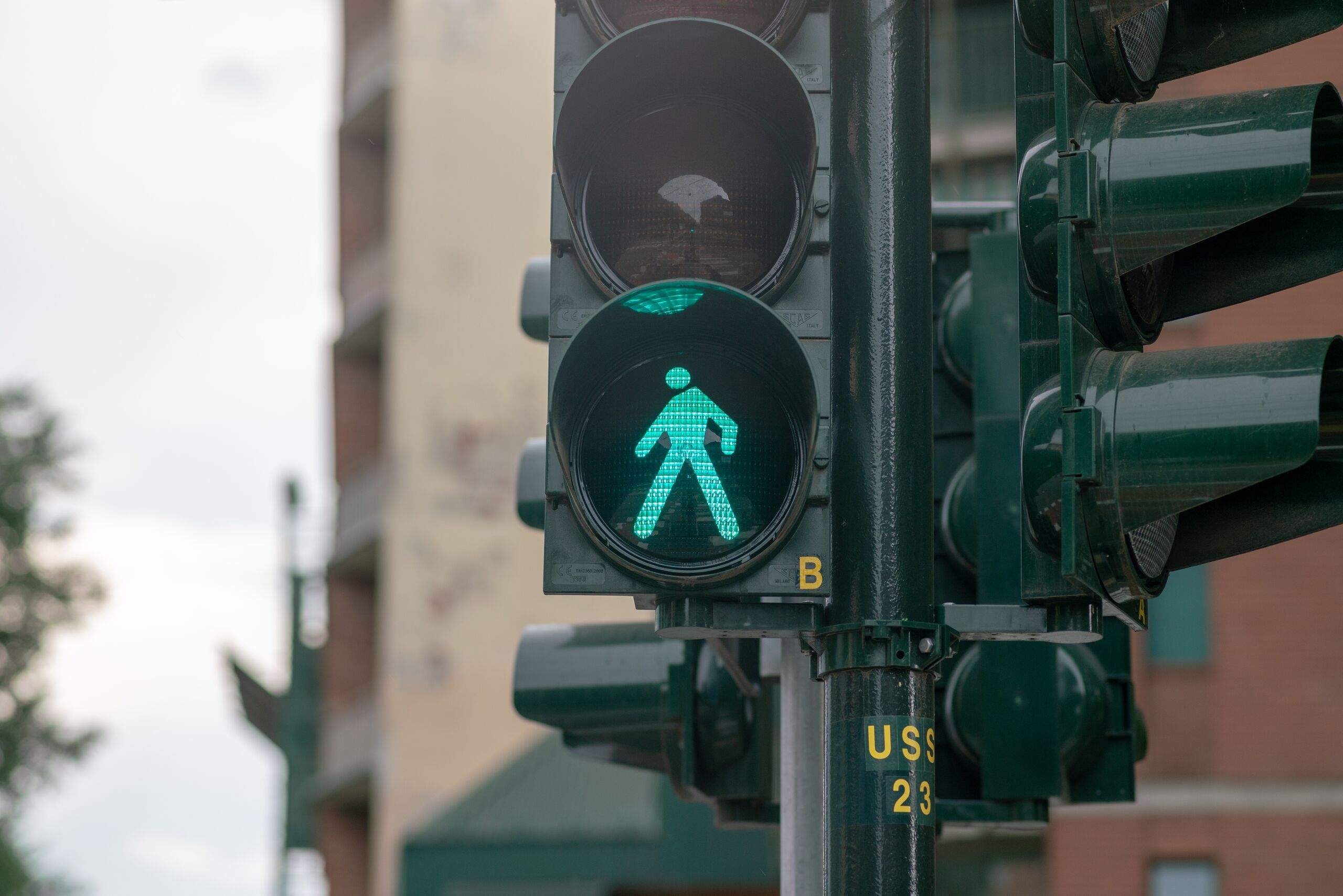 Green walk signal at a city intersection, showing pedestrian right-of-way after an accident in Tulsa