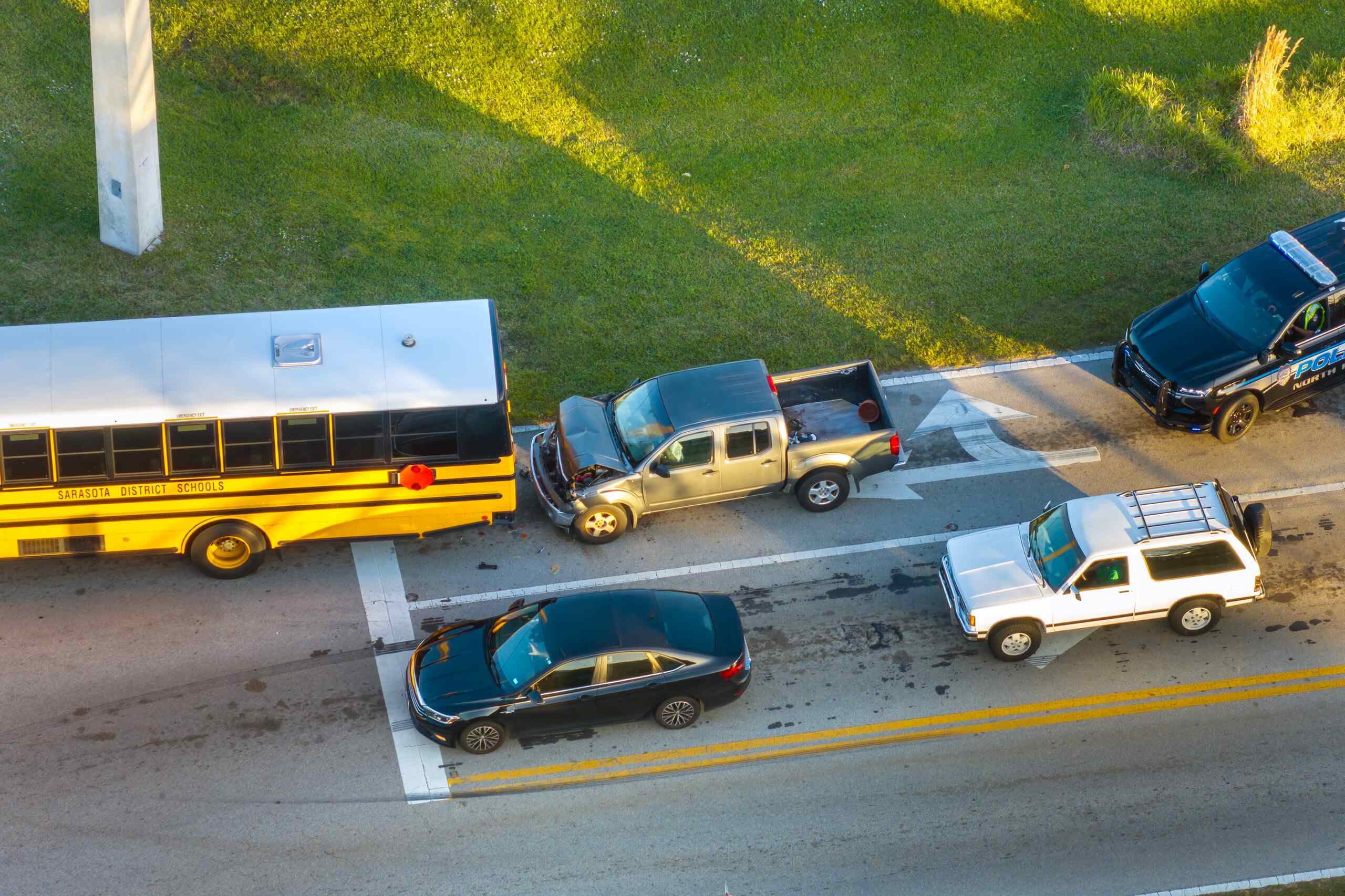 Aerial view of a school bus rear-end collision with multiple vehicles involved, highlighting school bus accident liability in Oklahoma