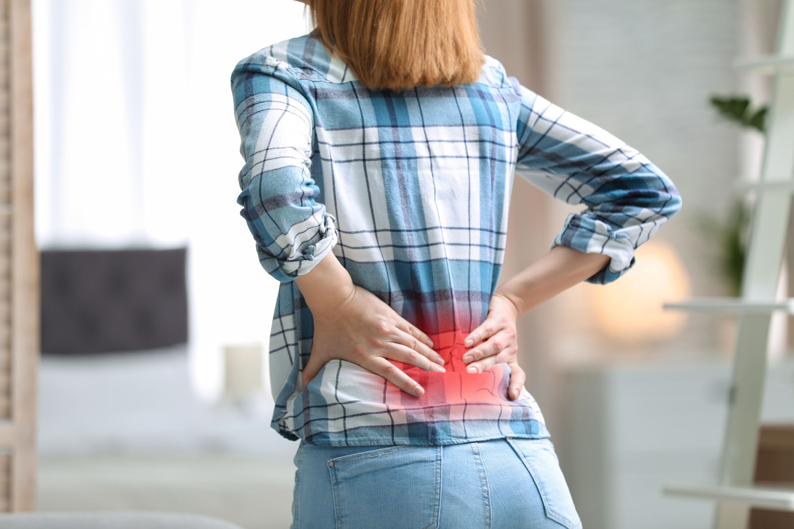 An Owasso resident suffering from chronic back pain following a car accident on US-169, representing the types of cases handled by Owasso personal injury attorneys.