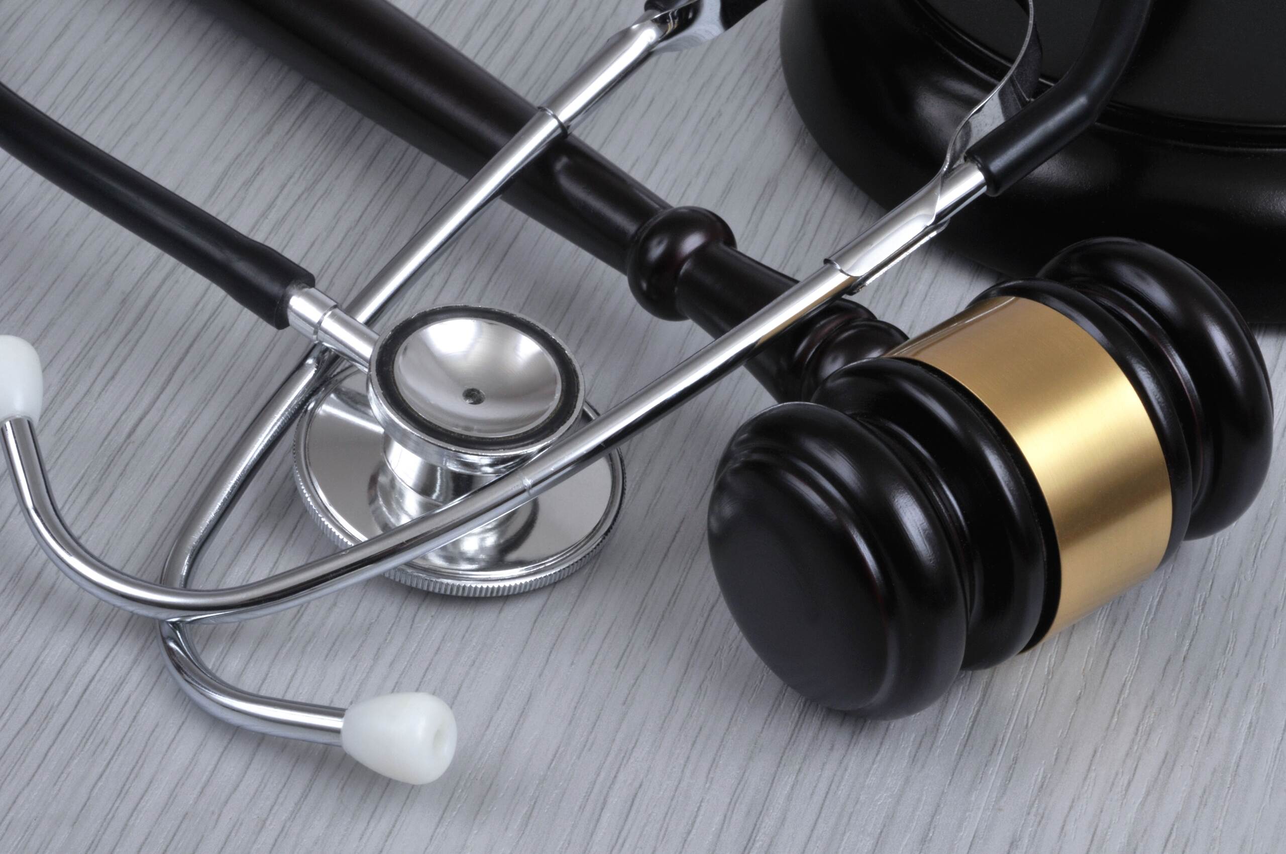 A stethoscope resting next to a legal gavel, symbolizing the intersection of medicine and law in an Oklahoma medical malpractice case.