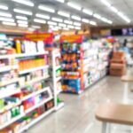 A blurred interior view of an Oklahoma convenience store, representing retailers that can be held liable for illegal alcohol sales to intoxicated drivers.