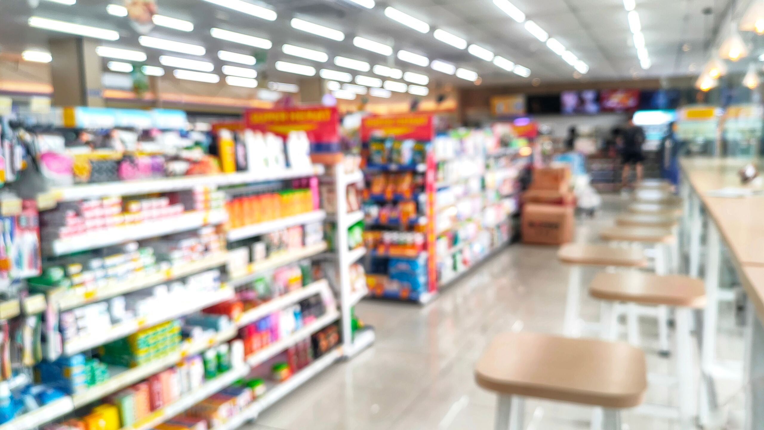 A blurred interior view of an Oklahoma convenience store, representing retailers that can be held liable for illegal alcohol sales to intoxicated drivers.