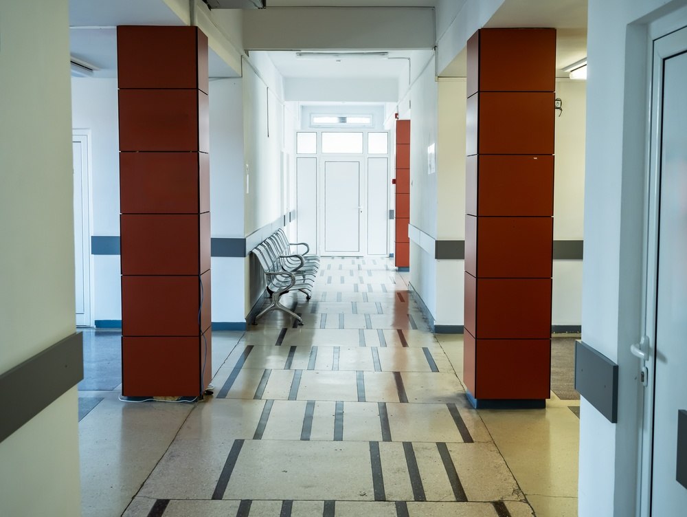 Empty hospital corridor with unattended waiting area, illustrating short-staffed conditions