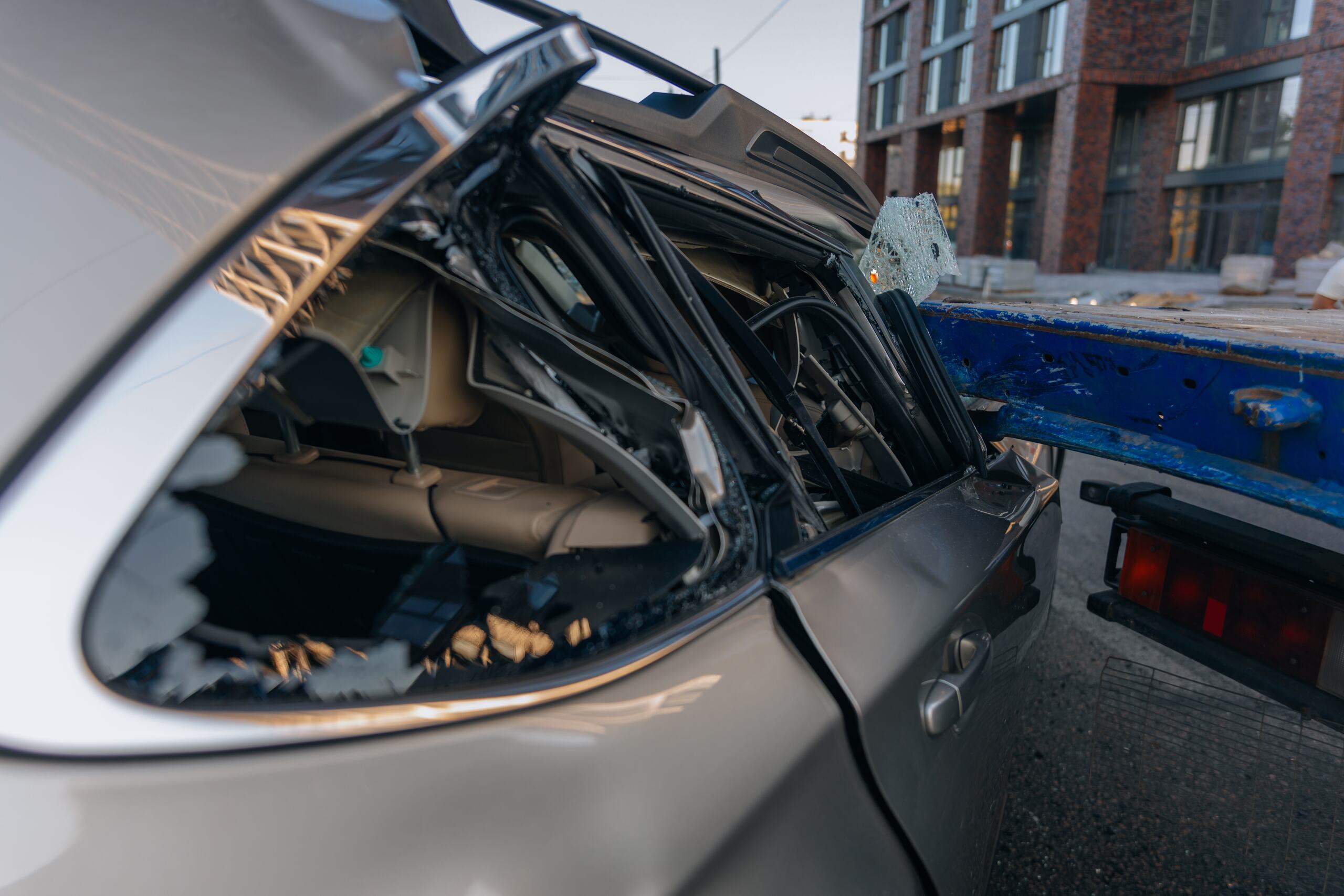 A close up view of a crushed vehicle window after a collision highlights serious property damage when considering how long does a truck accident lawsuit take in Oklahoma.