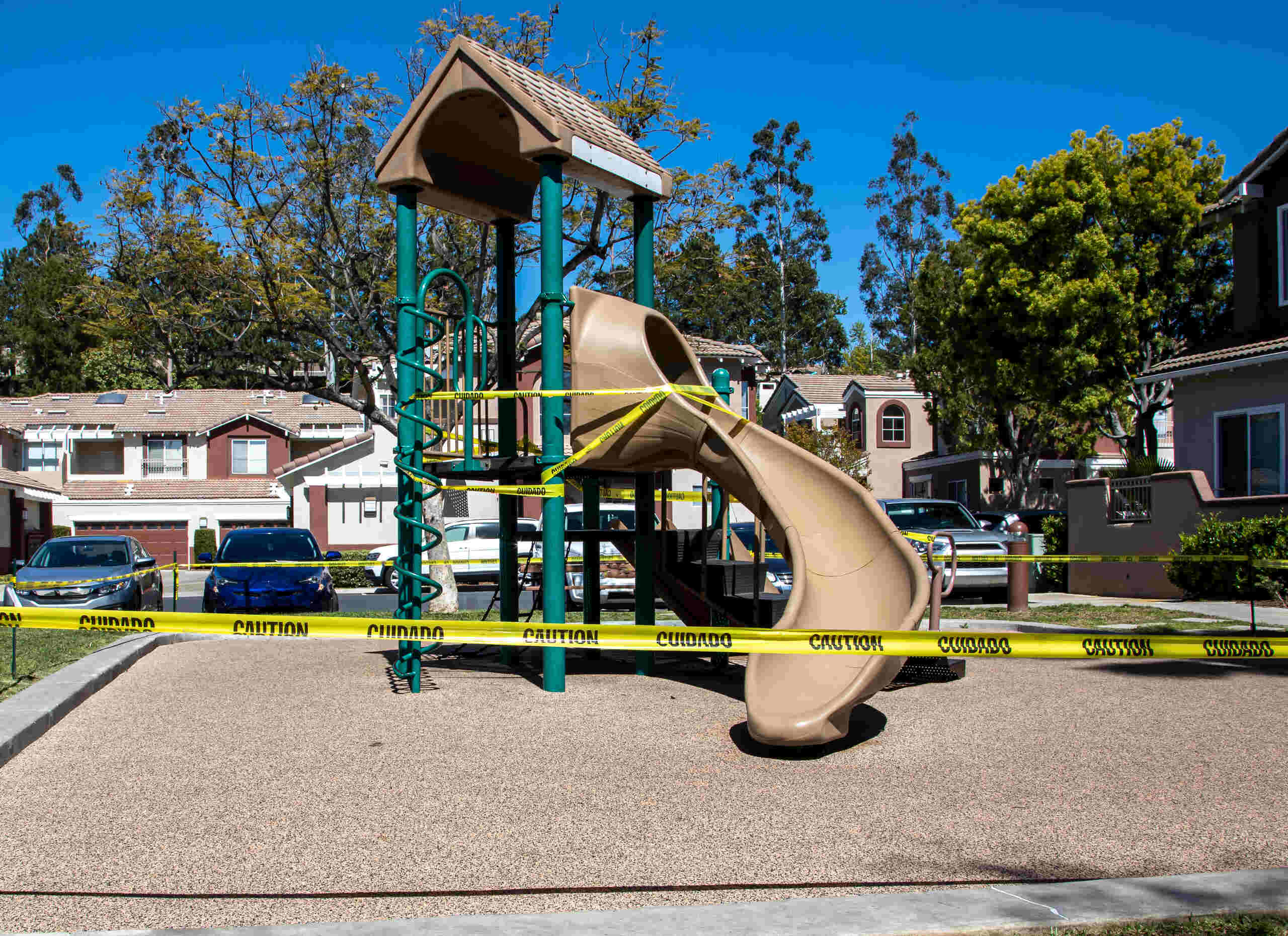 Closed playground blocked by yellow caution tape for Tulsa premises liability lawyers.