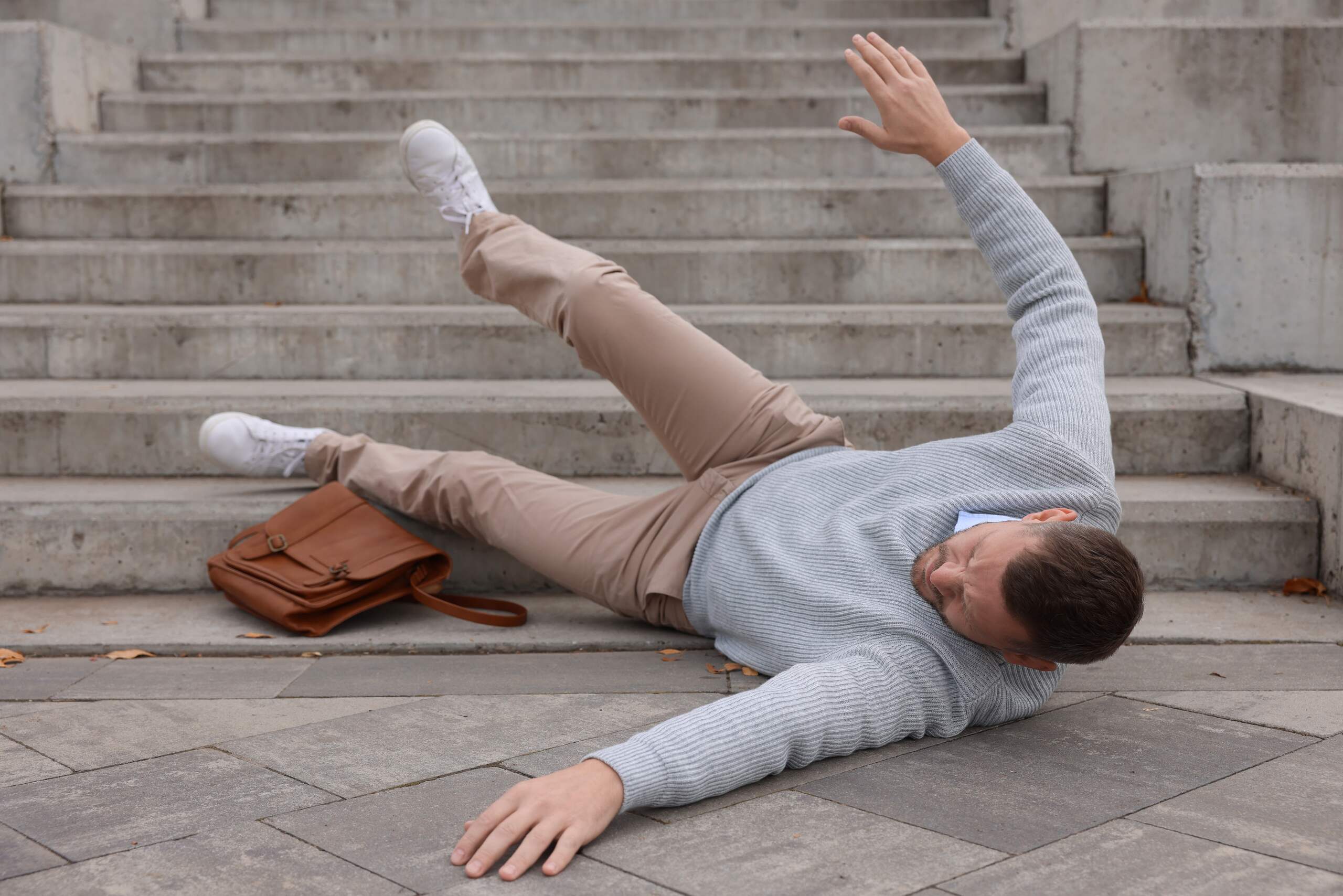 Man slipping and falling down outdoor stairs for Tulsa slip and fall lawyers.